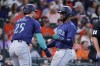Seattle Mariners' Dylan Moore (25) and Victor Robles, right, celebrate after they both scored on a two-run RBI single by Justin Turner against the Houston Astros during the sixth inning of a baseball game Wednesday, Sept. 25, 2024, in Houston. (AP Photo/Michael Wyke)