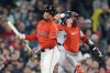 Boston Red Sox's Enmanuel Valdez, left, reacts beside Minnesota Twins catcher Christian Vázquez, right, after being called out on strikes during the sixth inning of a baseball game, Friday, Sept. 20, 2024, in Boston. (AP Photo/Michael Dwyer)