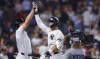 New York Yankees' Aaron Judge, center, celebrates with Giancarlo Stanton, left, after hitting a home run against the Baltimore Orioles during the seventh inning of a baseball game, Thursday, Sept. 26, 2024, in New York. (AP Photo/Noah K. Murray)