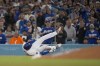 Los Angeles Dodgers' Freddie Freeman falls after grounding out during the seventh inning of a baseball game against the San Diego Padres, Thursday, Sept. 26, 2024, in Los Angeles. (AP Photo/Ashley Landis)