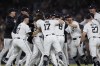 The Detroit Tigers, including Tyler Holton (87), Jace Jung (17), Matt Vierling (8), Zach McKinstry, Trey Sweeney (27) and Kerry Carpenter, celebrate after defeating the Chicago White Sox to win a wildcard spot in the major league baseball playoffs, Friday, Sept. 27, 2024, in Detroit. (AP Photo/Duane Burleson)