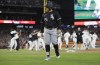 Chicago White Sox's Andrew Vaughn (25) walks off the field as the Detroit Tigers celebrate after making the playoffs after a win in a baseball game Friday, Sept. 27, 2024, in Detroit. (AP Photo/Duane Burleson)