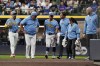 Milwaukee Brewers' Sal Frelick, center, walks off the field during the third inning of a baseball game against the New York Mets, Friday, Sept. 27, 2024, in Milwaukee. Frelick left the game after suffering an injury. (AP Photo/Aaron Gash)