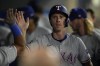 Texas Rangers' Matt Duffy celebrates in the dugout after scoring off of a double by Nathaniel Lowe during the eighth inning of a baseball game against the Los Angeles Angels in Anaheim, Calif., Saturday, Sept. 28, 2024. (AP Photo/Ashley Landis)