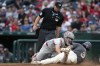 Washington Nationals outfielder Dylan Crews (3) slides and is out by Philadelphia Phillies catcher Garrett Stubbs during the second inning of a baseball game against the Philadelphia Phillies, Sunday, Sept. 29, 2024, in Washington. (AP Photo/Jose Luis Magana)