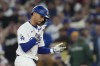 Los Angeles Dodgers' Mookie Betts celebrates after hitting a single during the first inning of a baseball game against the San Diego Padres Thursday, Sept. 26, 2024, in Los Angeles. (AP Photo/Ashley Landis)