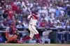 Philadelphia Phillies' Kyle Schwarber follows through after hitting a home run off of New York Mets pitcher Kodai Senga during the first inning of Game 1 of a baseball NL Division Series, Saturday, Oct. 5, 2024, in Philadelphia. (AP Photo/Matt Slocum)