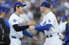 Los Angeles Dodgers' Shohei Ohtani, left, shakes hands with Freddie Freeman before Game 1 of baseball's NL Division Series against the San Diego Padres, Saturday, Oct. 5, 2024, in Los Angeles. (AP Photo/Ashley Landis)