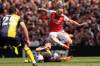 Arsenal&rsquo;s Leandro Trossard, top, challenges for the ball with Bournemouth&rsquo;s Alex Scott during the English Premier League soccer match between Arsenal and Bournemouth at Emirates Stadium in London, England, Saturday, May 4, 2024. (AP Photo/Frank Augstein)