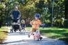 Ruth Bonneville / Free Press
                                Theo Hildebrand, who turns four next month, races ahead of his two-year-old sister Lucy and his granddad while out for a summer-like jaunt on his slider bike in River Heights Thursday.