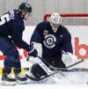 John Woods / THE CANADIAN PRESS FILES
                                Winnipeg Jets goaltender Connor Hellebuyck saves a shot during NHL training camp in Winnipeg, Friday.