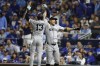 New York Yankees' Giancarlo Stanton is congratulated by teammate Jazz Chisholm Jr. (13) after hitting a solo home run during the eighth inning in Game 3 of an American League Division baseball playoff series against the Kansas City Royals Wednesday, Oct. 9, 2024, in Kansas City, Mo. (AP Photo/Colin Braley)
