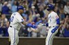 Kansas City Royals' Bobby Witt Jr. (7) is congratulated by teammate Salvador Perez (13) after scoring during the sixth inning in Game 4 of an American League Division baseball playoff series against the New York Yankees Thursday, Oct. 10, 2024, in Kansas City, Mo. (AP Photo/Charlie Riedel)