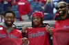 Cleveland Cavaliers players, from left, Donovan Mitchell, Darius Garland and Tristan Thompson pose before Game 5 in baseball's American League Division Series between the Detroit Tigers and the Cleveland Guardians, Saturday, Oct. 12, 2024, in Cleveland. (AP Photo/Phil Long)