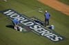Workers prepare the field for the baseball World Series between the Los Angeles Dodgers and the New York Yankees, Thursday, Oct. 24, 2024, in Los Angeles. (AP Photo/Julio Cortez)