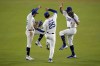 Los Angeles Dodgers Chris Taylor (3), Tommy Edman (25) and Mookie Betts celebrate after Game 2 of the baseball World Series against the New York Yankees, Saturday, Oct. 26, 2024, in Los Angeles. The Dodgers won 4-2. (AP Photo/Julio Cortez)