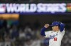 Los Angeles Dodgers pitcher Yoshinobu Yamamoto leaves the games against the New York Yankees during the seventh inning in Game 2 of the baseball World Series, Saturday, Oct. 26, 2024, in Los Angeles. (AP Photo/Ashley Landis)