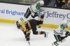 Boston Bruins center Trent Frederic (11) hits the ice as Dallas Stars defenseman Mathew Dumba (3) and right wing Evgenii Dadonov (63) vie for position in the first period of an NHL hockey game, Thursday, Oct. 24, 2024, in Boston. (AP Photo/Steven Senne)