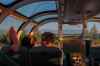 Passengers relax inside the skyline car as the sun sets Thursday, Aug. 8, 2024, between Churchill and Gilliam, Manitoba. (AP Photo/Joshua A. Bickel)