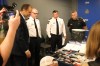 Justice Minister Matt Wiebe, WPS Insp. Elton Hall, WPS deputy chief Gene Bowers and WPS Const. Jason Michalyshen assess the guns, drugs and luxury items seized as part of Project Soft Landing on May 1, 2024. (Tyler Searle / Winnipeg Free Press)