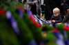 A boy places a poppy on a wreath during a Remembrance Day ceremony at Victory Square in Vancouver, on Monday, November 11, 2024. THE CANADIAN PRESS/Ethan Cairns