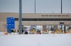 A lone car enters the US as people block highway 75 with heavy trucks and farm equipment and access to the Canada/US border crossing at Emerson, Man., Thursday, Feb. 10, 2022. Two men are to stand trial on human smuggling charges this week, almost three years after a family from India was found frozen to death on the border between Manitoba and Minnesota. THE CANADIAN PRESS/John Woods