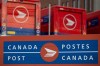 Canada Post signage and parked vehicles are seen at a Canada Post mail sorting facility during nation-wide strike action in Ottawa, on Monday, Nov. 18, 2024. The U.S. Postal Service has suspended accepting mail headed to Canada due to the strike by Canada Post workers.THE CANADIAN PRESS/Spencer Colby
