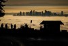 People are silhouetted as they view and photograph fog shrouding the Vancouver area, from Cypress Mountain in West Vancouver, B.C., Dec. 3, 2024. THE CANADIAN PRESS/Darryl Dyck