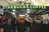 FILE - Shoppers at the Walden Galleria in Buffalo, NY, stop by the Starbucks kiosk on Nov. 30, 2024. (AP Photo/Gene J. Puskar, File)