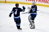 Winnipeg Jets goaltender Connor Hellebuyck (37) celebrates his shutout against the Nashville Predators with Neal Pionk (4) after the third period of their NHL hockey game in Winnipeg, Monday, Dec. 30, 2024. THE CANADIAN PRESS/Fred Greenslade