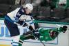 Winnipeg Jets defenceman Logan Stanley (left) lays a hit on Dallas Stars&rsquo; Logan Stankoven Sunday.