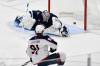 Columbus Blue Jackets&rsquo; Kent Johnson (91) scores on Winnipeg Jets&rsquo; goaltender Eric Comrie (1) during third period NHL hockey action in Winnipeg, Sunday, Dec. 8, 2024. THE CANADIAN PRESS/Fred Greenslade