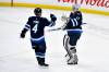 FRED GREENSLADE / THE CANADIAN PRESS
                                Jets&rsquo; goaltender Connor Hellebuyck celebrates regular-season victory number 299 and his fifth shutout of the season Monday night with blue-liner Neal Pionk.