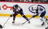 Colorado Avalanche center Casey Mittelstadt, left, collects the puck as Winnipeg Jets center Cole Perfetti defends in the third period of Tuesday&rsquo;s game. (David Zalubowski/ The Associated Press)