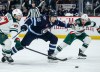 Winnipeg Jets' Morgan Barron (36) breaks through Minnesota Wild Declan Chisholm (47) and Jared Spurgeon (46) during the second period. (John Woods / The Canadian Press)