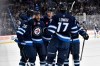 Winnipeg Jets' Dylan Demelo (2) celebrates his goal against the Nashville Predators with Morgan Barron (36), Logan Stanley (64) and Adam Lowry (17) during the second period of their NHL hockey game in Winnipeg, Monday, Dec. 30, 2024. THE CANADIAN PRESS/Fred Greenslade