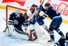 Winnipeg Jets goaltender Connor Hellebuyck (37) keeps his eye on the puck as Dylan DeMelo (2) defends against Colorado Avalanche's Ross Colton (20) during third period NHL action in Winnipeg on Saturday, January 11, 2025. THE CANADIAN PRESS/John Woods