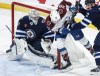 Winnipeg Jets goaltender Connor Hellebuyck (37) keeps his eye on the puck as Dylan DeMelo (2) defends against Colorado Avalanche's Ross Colton (20) during third-period NHL action in Winnipeg on Saturday, January 11, 2025. THE CANADIAN PRESS/John Woods