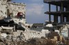 Samir al-Baghdadi, 46, jumps from a wall of his family home which was destroyed during the civil war in the Qaboun neighborhood of Damascus, Syria, Saturday, Jan. 11, 2025.(AP Photo/Omar Sanadiki)