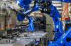 MIKE DEAL / FREE PRESS
                                Joel Vanderveen, mechanical engineering technologist, programs a robot.