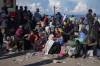 Displaced Palestinians gather with their belongings near a roadblock, as they wait to return to their homes in the northern part of the Gaza Strip on Sunday, Jan. 26, days after the ceasefire deal between Israel and Hamas came into effect. (Abdel Kareem Hana/Associated Press)