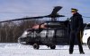A Royal Canadian Mounted Police officer looks over the force's new Black Hawk helicopter to be used to fulfil their border mandate in St-Antoine-Abbe, Que., on Thursday, Jan.30, 2025. THE CANADIAN PRESS/Christinne Muschi