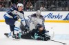 Winnipeg Jets defenseman Logan Stanley, left, and goaltender Connor Hellebuyck, back center, collide with Seattle Kraken center Jaden Schwartz (17) as they stop his run on the goal during the second period of an NHL hockey game Thursday, Oct. 24, 2024, in Seattle. (AP Photo/Lindsey Wasson)