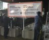 RCMP officers unwrap a new warning sign for asylum seekers on the border at Roxham Road from New York into Canada March 25, 2023, in Champlain, New York. THE CANADIAN PRESS/Ryan Remiorz