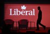 A stagehand works on the stage in between presenters at the 2023 Liberal National Convention in Ottawa, on Thursday, May 4, 2023. THE CANADIAN PRESS/Justin Tang