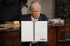 President Donald Trump holds up a signed executive order as he addresses a joint session of Congress at the Capitol in Washington on Tuesday, March 4, 2025. THE CANADIAN PRESS/AP-Alex Brandon