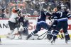 Winnipeg Jets goaltender Connor Hellebuyck (37) saves the shot as Dylan Samberg (54) defends against the Philadelphia Flyers during second period NHL action in Winnipeg on Saturday, March 1, 2025. THE CANADIAN PRESS/John Woods