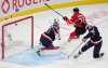 Canada's Connor McDavid (97) scores on United States goaltender Connor Hellebuyck (37) as United States' Charlie McAvoy (25) looks on during first period 4 Nations Face-Off hockey action in Montreal on Feb. 15, 2025. THE CANADIAN PRESS/Christinne Muschi