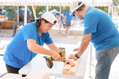 Employees at Manitoba Blue Cross make 50 beds for local children in support of Sleep in Heavenly Peace.