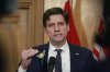 B.C. Premier David Eby speaks to media following the throne speech at the legislature in Victoria, Tuesday, Feb. 18, 2025. THE CANADIAN PRESS/Chad Hipolito
